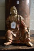A very early wood and stone polychrome decorated seated Buddha.