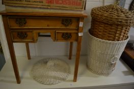 A small pine lowboy and wicker baskets.