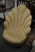 An unusual upholstered shell shaped bedroom chair.