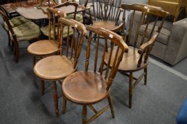 A spindle back armchair and three similar side chairs.