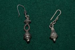 A pair of decorative earrings.