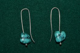 A pair of decorative earrings.