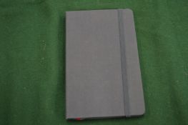 A Moleskine Voyageur blue cloth bound notebook.