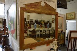 Gilt framed rectangular mirror with broken arched pediment.