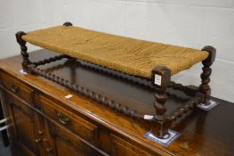 A long oak framed stool.