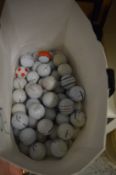 A quantity of golf balls.