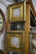 A pair of decorative plaster reliefs in gilt frames (faults).