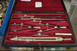A cased drawing instrument set.