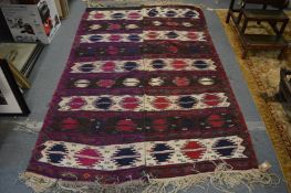 A Kilim style rug in two parts, stitched down the centre, 225cm x 150cm.