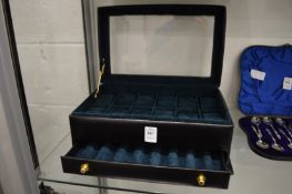 A black leather watch and cufflink box.