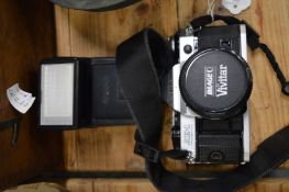 A Cannon AE1 camera with flash.