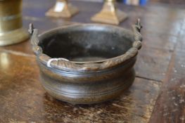 An early bronze bowl with swing handle.