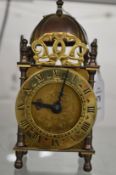 Miniature lantern clock with quartz movement.