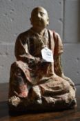 A very early wood and stone polychrome decorated seated Buddha.