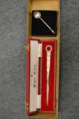 A cased silver letter opener and a small spoon.