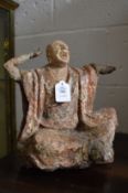 A very early wood and stone polychrome decorated seated Buddha.