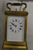 A brass carriage clock with alarm.