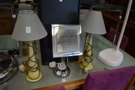 A pair of decorative table lamps and an illuminated make-up mirror.