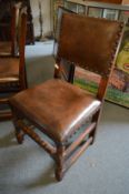 A set of eight oak framed close-nailed leather upholstered dining chairs.