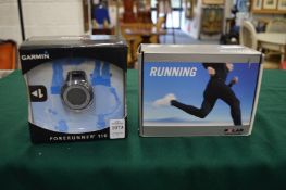 A boxed Garmin Forerunner 110 watch and another item.
