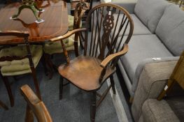A wheel back Windsor armchair.