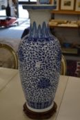 A pair of large Chinese blue and white vases with hardwood stands (one with rim chips).