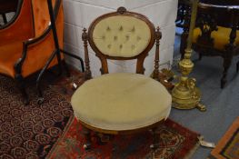 A Victorian walnut bedroom chair with carved show wood frame.