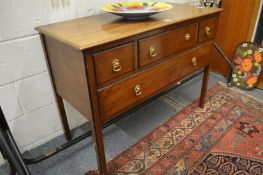 A mahogany side table with four drawers.