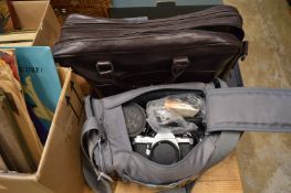 A Pentax MV1 camera with accessories together with a holdall.