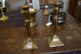 A pair of brass candlesticks.