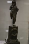 An early cast bronze figure of a man with a toga draped across his shoulder on a pedestal base.