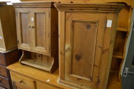 A pine hanging two door cupboard and a corner cupboard.