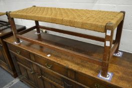 An Arts and Crafts design oak framed long stool.