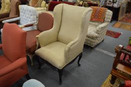 A small wing armchair.