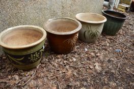 Four large glazed circular planters.