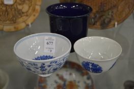 Two small Chinese blue and white bowls and a blue glazed bowl.