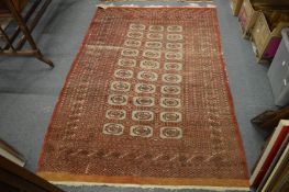 A Bokhara rug, worn 185cm x 126cm.