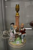 A Dresden porcelain figural lamp base 'ring-a-ring o' roses'.