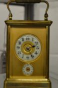 A brass carriage clock with alarm.