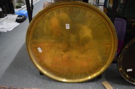 An engraved brass circular tray.