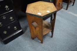 A small oak hexagonal two-tier occasional table.