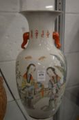 A late 19th century famille jaune twin handled vase painted with figures.