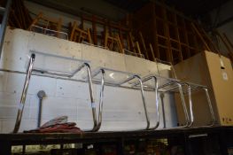 A set of four chrome and plexiglass dining chairs.