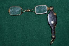 A small pair tortoiseshell lorgnettes.