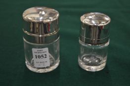 Two silver mounted glass dressing table jars.