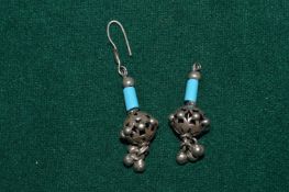 A pair of decorative earrings.