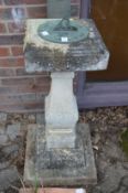 A reconstituted stone pedestal sundial.