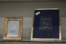 Two silver photograph frames.
