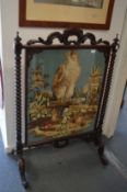 A good Victorian carved rosewood firescreen with needlework panel depicting bird of prey on a