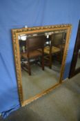 A gilt framed mirror.
